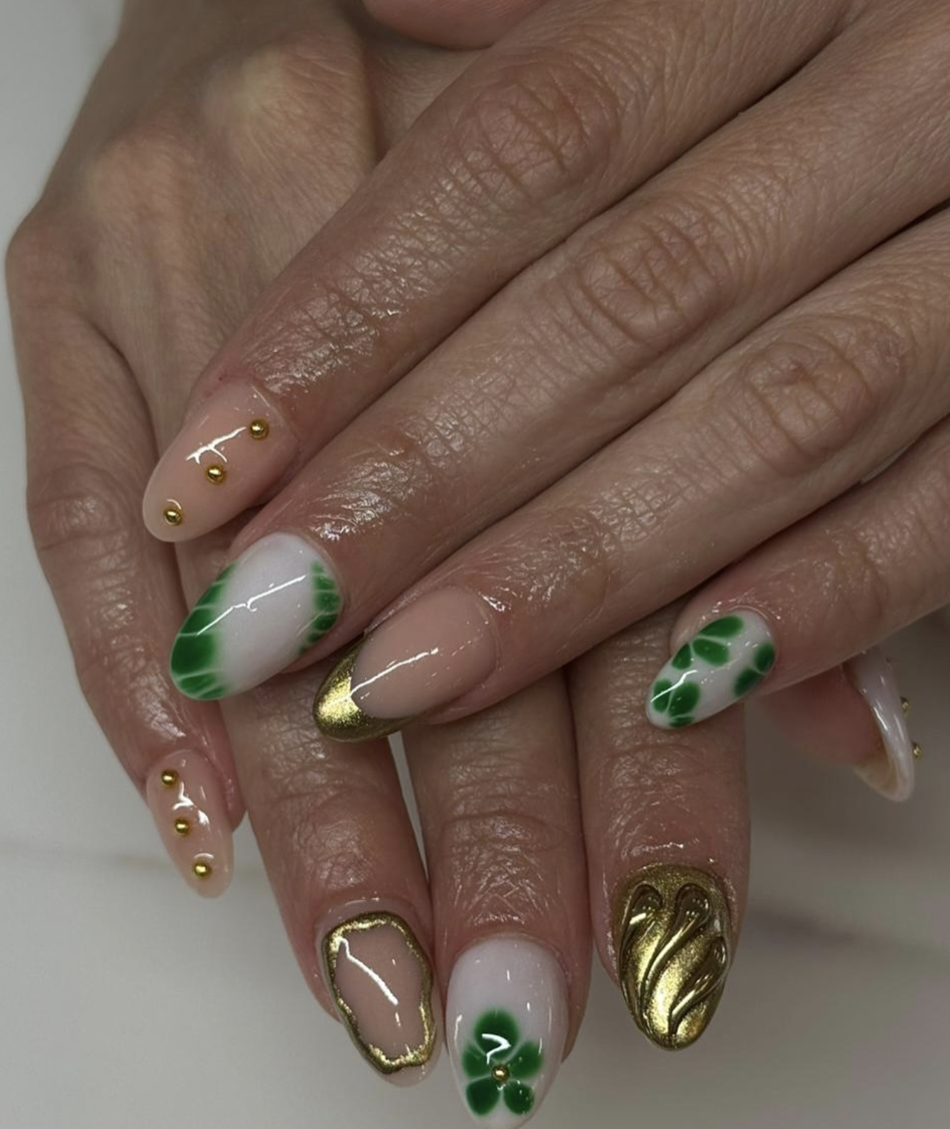 Green and gold seasonal clover nail design
